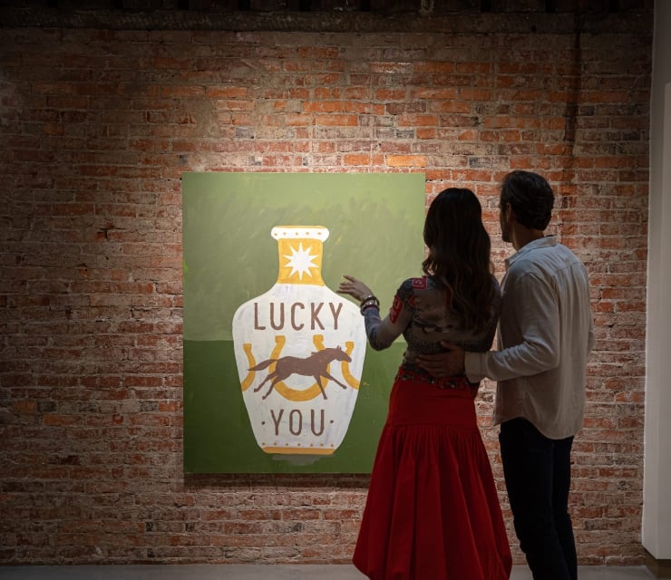 A couple looking at some art hanging in a gallery