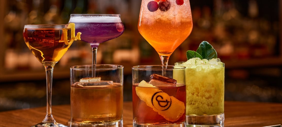 An array of colorful cocktails on a bartop at the Untitled Nashville