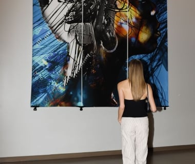 A woman looks at an artwork on display at the Untitled Nashville hotel
